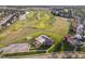 Aerial view of a community featuring a pool, playground, green spaces, and a golf course at 4052 Diamond Row, Greenwood, IN 46143