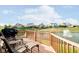 Outdoor seating overlooking the pond with fountain on a wooden deck with grill at 4052 Diamond Row, Greenwood, IN 46143