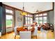 Bright dining room with large windows, hardwood floors, and elegant chandelier at 4052 Diamond Row, Greenwood, IN 46143