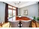 Dining room with a wooden table, six chairs, and a large window with natural light at 4052 Diamond Row, Greenwood, IN 46143