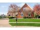 Charming brick home boasts a well-manicured lawn and flowering trees enhancing curb appeal at 4052 Diamond Row, Greenwood, IN 46143