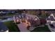 Inviting brick home with a brick driveway, manicured landscaping, and a well-lit entrance at 4052 Diamond Row, Greenwood, IN 46143
