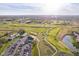 Extensive aerial view of the golf course, a clubhouse, surrounding neighborhoods, and serene ponds at 4052 Diamond Row, Greenwood, IN 46143