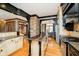 Beautiful kitchen with hardwood floors, granite counters, stone accents, and stainless steel appliances at 4052 Diamond Row, Greenwood, IN 46143
