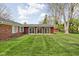 Large, well-maintained backyard with expansive lawn and a row of sliding glass doors at 426 Oakwood Dr, Indianapolis, IN 46260
