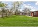 Expansive backyard featuring well-maintained lawn and trees, offering an outdoor space perfect for enjoying the outdoors at 426 Oakwood Dr, Indianapolis, IN 46260