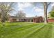 Spacious backyard features well-maintained lawn and mature trees providing ample outdoor space and exterior home view at 426 Oakwood Dr, Indianapolis, IN 46260