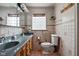 Bathroom with a double sink vanity, neutral tile, and lots of lighting at 426 Oakwood Dr, Indianapolis, IN 46260