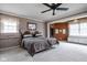 Large bedroom with patterned wallpaper, a ceiling fan, two beds, and natural light from two windows at 426 Oakwood Dr, Indianapolis, IN 46260