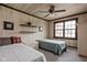 Cozy bedroom with two twin beds, wood paneled walls, a ceiling fan, and large windows for natural light at 426 Oakwood Dr, Indianapolis, IN 46260