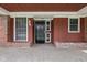 Inviting front entrance featuring a black door, brick accents, and ample natural light at 426 Oakwood Dr, Indianapolis, IN 46260