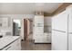 Well-lit kitchen featuring white cabinetry and a functional layout with access to other rooms at 426 Oakwood Dr, Indianapolis, IN 46260