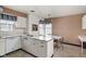 Retro kitchen design, with white cabinetry, adjacent dining area, and lots of natural light at 426 Oakwood Dr, Indianapolis, IN 46260