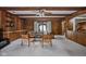 Spacious living room with wooden beams, wood paneling, built-in shelving, and sliding glass doors at 426 Oakwood Dr, Indianapolis, IN 46260