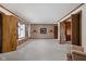 Spacious living room featuring neutral walls, wall sconces, large window, and doorway access to other rooms at 426 Oakwood Dr, Indianapolis, IN 46260