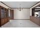 Open living room with neutral walls, and light carpet with a chandelier and window seat at 426 Oakwood Dr, Indianapolis, IN 46260