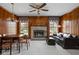 Cozy living room and dining area with wood paneling, fireplace, and comfortable seating at 426 Oakwood Dr, Indianapolis, IN 46260