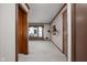 Bright living room featuring neutral walls, wall sconces, large window, and doorway access to other rooms at 426 Oakwood Dr, Indianapolis, IN 46260