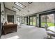 Bright sunroom features skylights, exposed brick, a ceiling fan, glass doors that lead to exterior, and seating area at 426 Oakwood Dr, Indianapolis, IN 46260