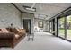 Bright sunroom features skylights, brick walls, a ceiling fan, glass doors, and cozy seating with natural lighting at 426 Oakwood Dr, Indianapolis, IN 46260