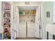 This laundry room features a washer, dryer, and shelving for storage at 43 Dominion Dr, Zionsville, IN 46077