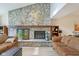 Living room showcasing a stunning stone fireplace, skylight, and stylish furniture at 43 Dominion Dr, Zionsville, IN 46077