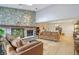 Open living area with a striking stone fireplace, skylight, and comfortable seating at 43 Dominion Dr, Zionsville, IN 46077