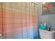Toilet and shower with a colorful curtain and wall art. Perfect for a cozy bathroom at 43 Dominion Dr, Zionsville, IN 46077