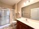 Bathroom featuring a walk-in shower with glass doors, tile floors, and a large vanity at 4327 Switchgrass Way, Indianapolis, IN 46237