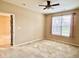 Bedroom with large window, plush carpet, ceiling fan, and ample natural light at 4327 Switchgrass Way, Indianapolis, IN 46237