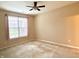 Neutral bedroom with large window, plush carpet, ceiling fan, and ample natural light at 4327 Switchgrass Way, Indianapolis, IN 46237