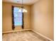 Traditional dining room featuring neutral walls, chandelier, and window with brick building view at 4327 Switchgrass Way, Indianapolis, IN 46237