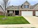 Inviting single-Gathering home featuring an attached two-car garage and well-maintained lawn in a suburban neighborhood at 4327 Switchgrass Way, Indianapolis, IN 46237
