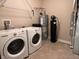 Functional laundry room with washer, dryer, water heater, and water softener at 4327 Switchgrass Way, Indianapolis, IN 46237