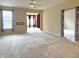 Spacious living room featuring plush carpet and large windows creating bright and inviting atmosphere at 4327 Switchgrass Way, Indianapolis, IN 46237