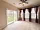 Bright living room with sliding doors to the outside and windows with lovely pond views at 4327 Switchgrass Way, Indianapolis, IN 46237