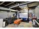 Cozy finished basement featuring a projector screen, exposed ducts and painted walls at 433 Eastern Ave, Indianapolis, IN 46201