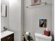 Bathroom shows a sink, toilet, mirror, painting, and greenery at 433 Eastern Ave, Indianapolis, IN 46201