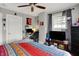 Bedroom featuring colorful bedspread, ceiling fan, and office desk at 433 Eastern Ave, Indianapolis, IN 46201