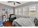 Comfortable bedroom featuring hardwood floors, large window, and a recliner chair at 433 Eastern Ave, Indianapolis, IN 46201