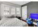 Bedroom features hardwood floors, large windows, and a TV at 433 Eastern Ave, Indianapolis, IN 46201