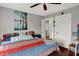 Bedroom featuring a colorful patterned bedspread, ceiling fan, and two closets at 433 Eastern Ave, Indianapolis, IN 46201