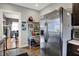 Kitchen with stainless steel fridge and ample storage and shelving adjacent to the door way at 433 Eastern Ave, Indianapolis, IN 46201