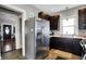 Spacious kitchen shows stainless steel refrigerator, and ample dark cabinetry, with door to another room at 433 Eastern Ave, Indianapolis, IN 46201