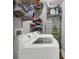 Functional laundry room featuring a washer, dryer, and shelving for storage at 433 Eastern Ave, Indianapolis, IN 46201