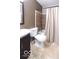 Cozy bathroom with shower-tub combination, neutral tile, and a dark wood vanity, creating a warm and inviting space at 4421 Greenmeadow Ct, Indianapolis, IN 46235