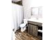 Modern bathroom featuring updated vanity with sliding barn door detail, new fixtures, and sleek design elements at 4421 Greenmeadow Ct, Indianapolis, IN 46235