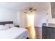 Bright, spacious bedroom featuring a ceiling fan, hardwood floors, and a comfortable bed with modern decor at 4421 Greenmeadow Ct, Indianapolis, IN 46235