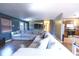 Spacious living room area with hardwood floors, a large sectional sofa, and access to the kitchen at 4421 Greenmeadow Ct, Indianapolis, IN 46235