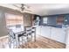 Open-concept living space with hardwood floors, a dining table, a brick fireplace, and a comfortable sofa at 4421 Greenmeadow Ct, Indianapolis, IN 46235